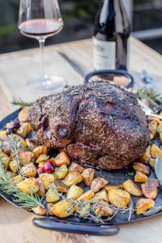 A smoked leg of lamb roast on a serving platter over a side of roasted potatoes and a glass of wine. Smoked Leg Of Lamb, Butter Wine Sauce, Leg Of Lamb Recipe, Boneless Leg Of Lamb, Holiday Dinner Recipes, Lamb Leg Recipes, Dinner Centerpieces, Wine Butter, Lamb Recipe