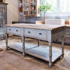 an old fashioned kitchen island with two drawers on each side and a sink in the middle