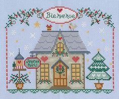 a small house with christmas trees and decorations on the front, in blue background is an embroidered