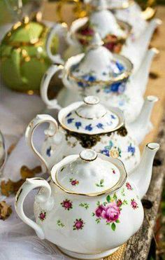 there are many teapots lined up on the table