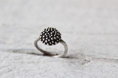 Dot ring-Sterling silver bubble ring-Statement ring-Granulation -Polka dot ring-Women's ring-Organic jewelry -Minimalist ring-Gift for her Sterling silver dot ring featuring an adjustable texture band with a circle full of bubbles ! The finish is matte and oxidized just to help the bubble effect stand out. This ring has been made using the lost wax method, an ancient technique to create jewelry. Minimal and organic Sterling silver ring! -The ring is adjustable,but please select your ring size for a perfect fit. -MATERIAL- Sterling silver  Every piece you purchase from Cyklu is unique and handmade with love and affection. Caring instructions: As the ring are made from sterling silver, please keep them in a box or pouch, to avoid darkening. In such a case they can be easily cleaned, with a s Unique Round Jewelry With Ring Detail, Elegant Stackable Rings With Oxidized Finish For Gifts, Unique Everyday Sterling Silver Rings, Modern Rings With Oxidized Finish For Gifts, Elegant Rings With Oxidized Finish, Elegant Oxidized Round Rings, Modern Silver Cluster Promise Ring, Stackable Sterling Silver Dome Ring, Dainty Stackable Dome Ring