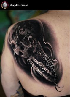 a black and white tattoo with a snake on it