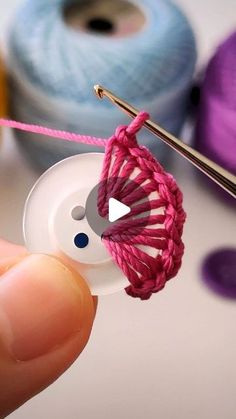 someone is knitting something with yarn on the sewing machine and it looks like an ornament