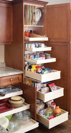 an open cabinet in a kitchen filled with food