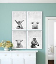 three black and white pictures hang on the wall above a dresser in a room with blue walls