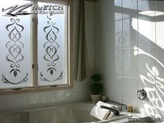 a bath tub sitting next to a window in a bathroom