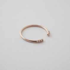 A slim, smooth open ring, detailed with 3 dainty crystals at each end.Size: 5.5 - 6.5 (slightly adjustable).Detailed with gorgeous AAA-rated cubic zirconia crystals.Our materials make for an amazing, high quality, seamless, jewelry piece with longevity. Rings are plated with 18k gold, 18k rose gold, or sterling silver and finished with a protective coating. A little secret we'll keep between us: it looks way more than it costs.Made In: China Delicate Gold Jewelry, Multi Ring, Textured Ring, Knuckle Rings, Between Us, Delicate Jewelry, Shoes With Jeans, Open Ring, Classic Silhouette