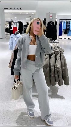 a woman taking a selfie in a clothing store