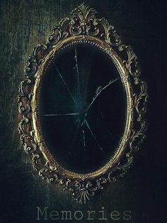 an ornate gold framed mirror with the word memories written on it's side in front of a dark wood background