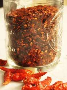 a glass jar filled with dried red peppers