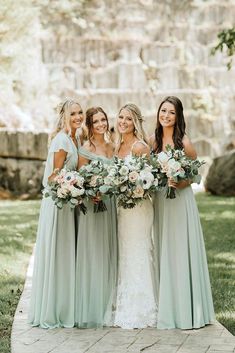 the bridesmaids are holding their bouquets together