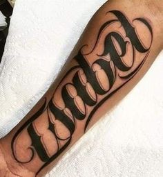 a man's arm with the word tattoo on it