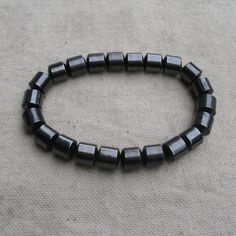 This Is A Handmade Magnetic Hematite Bead Bracelet. Stretchy Cord. Cylinder Beads. For Women Or Men. Hematite Is A Stone With Healing, Grounding, And Protection Properties. Note: Hematite Helps To Absorb Negative Energy And Calms In Times Of Stress Or Worry. Hematite Is A Very Protective Stone And Is Great To Carry To Help You Stay Grounded In Many Situations. Hematite Is Also Good For Working With The Root Chakra, Helping To Transform Negative Energies Into A More Positive Vibration. Hand-strung Hematite Bracelet As Gift, Hand-strung Hematite Bracelet Jewelry, Adjustable Hand-strung Hematite Beaded Bracelets, Black Hand-strung Hematite Jewelry, Adjustable Polished Hematite Beads, Stay Grounded, Hematite Beads, Root Chakra, Bead Bracelets