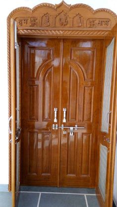 an ornate wooden door with glass panels