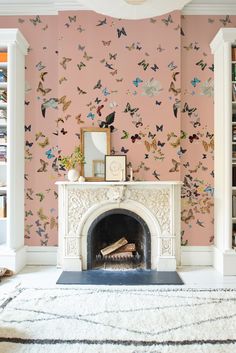 a living room with a fire place and wallpaper