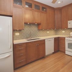 a kitchen with wooden cabinets and white appliances