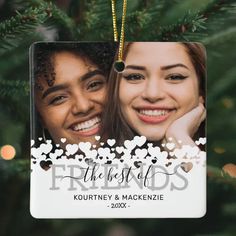 two women are smiling in front of a christmas ornament that says the best friends