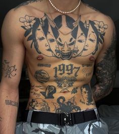 a shirtless man with tattoos on his chest