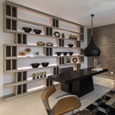 a black and white checkered floor in a room with shelves on the wall, two chairs