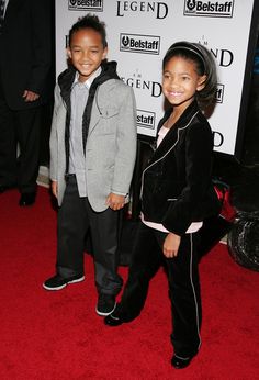 two young children standing on a red carpet