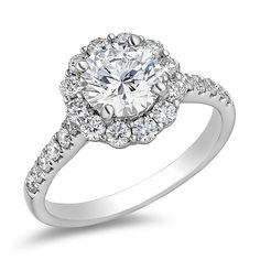 a white gold engagement ring with an oval center surrounded by round diamonds