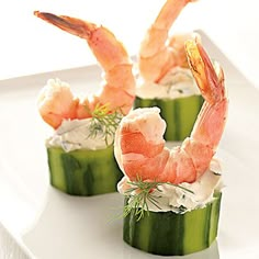 three shrimp and cucumber appetizers on a white plate