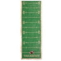 a green football field runner with the words touch down on it and a football in the middle