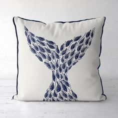 a blue and white pillow with a bird design on it