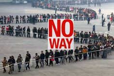 a crowd of people standing around a sign that says no way in front of them