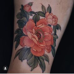 a close up of a person's foot with a flower tattoo on the leg