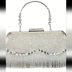 Womans Silver All Over Glittery Formal Handbag, Can Be Used As A Clutch And Has A Small Metal Handle That Is Able To Be Ticked Away.Has Frindge On Bottom. Perfect For Any Special Occasion Measurements Are 2.8in Wide Inside, 9.5 Inches Long And 4.5 Inches Tall. . Brand New In Package.Have This One Is All Silver Only Silver Bag With Rhinestone Fringe For Events, Silver Bags With Rhinestone Fringe For Events, Silver Embellished Bags For Night Out, Silver Bags With Rhinestone Fringe For Formal Occasions, Formal Silver Bag With Rhinestone Fringe, Silver Rhinestone Fringe Bag For Formal Occasions, Silver Bedazzled Bags For Events, Bedazzled Silver Rectangular Bag, Silver Bedazzled Rectangular Bags