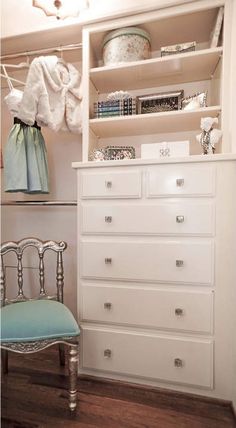 a white dresser and chair in a room