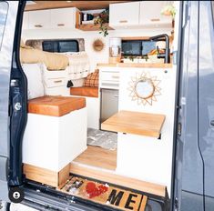 the interior of a camper van with its door open and shelves on the side