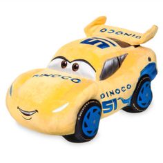 a yellow toy car with blue wheels on it's face and eyes, sitting in front of a white background