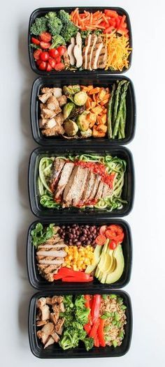 three plastic containers filled with food on top of a white table next to each other