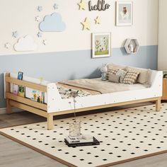 a child's bedroom with blue and white walls, wooden bed frame, and rug