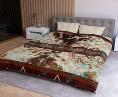 the bed is made up with brown and white comforters on it's sides