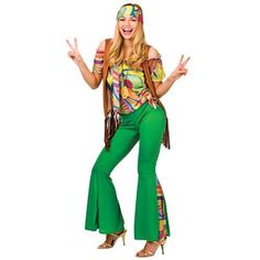 a woman wearing green pants and a colorful top posing with her hands in the air