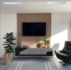 a living room with a large flat screen tv mounted to the side of a wall