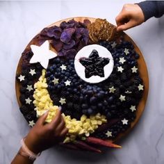 a plate that has food on it with stars and moon shapes in the top half