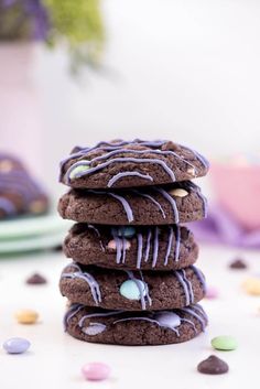 a stack of chocolate cookies with white frosting and sprinkles on top