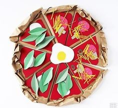 a paper plate that has some food on it with leaves and an egg in the middle