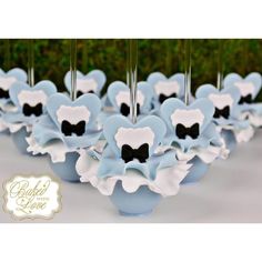 blue and white cupcakes with black bows on them