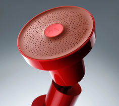 a close up of a red speaker on a gray background