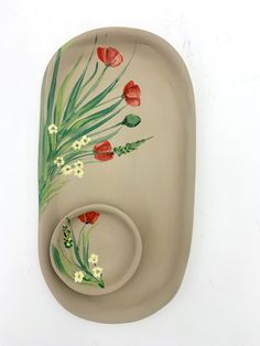 a ceramic dish with flowers painted on it