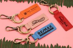 three keychains with the same name on them, one is red and one is blue