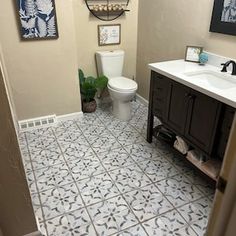 a bathroom with a toilet, sink and mirror