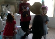 three children are playing with stuffed animals in the living room