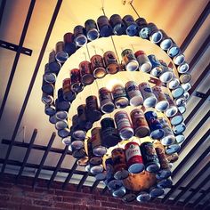 a chandelier made out of cans hanging from the ceiling