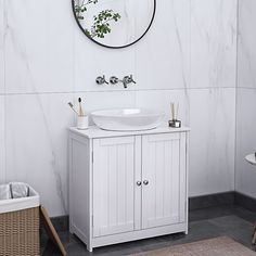 a white sink sitting under a mirror in a bathroom